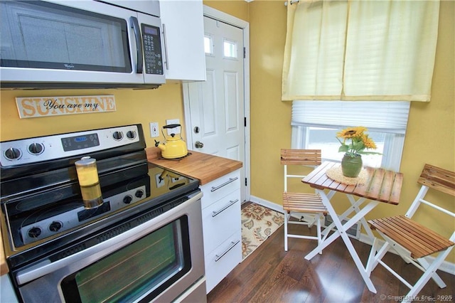 kitchen with white cabinetry, appliances with stainless steel finishes, and dark hardwood / wood-style floors