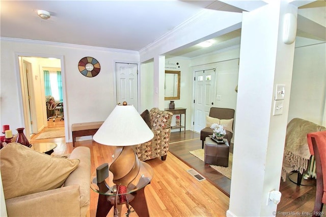 living room featuring hardwood / wood-style floors and ornamental molding