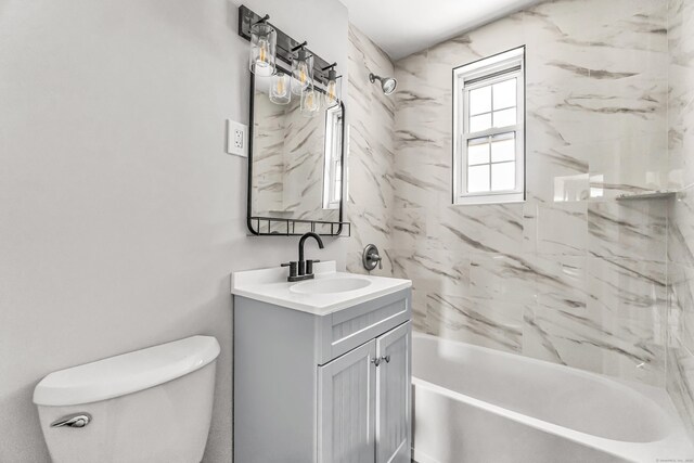 full bathroom with toilet, tiled shower / bath, and vanity