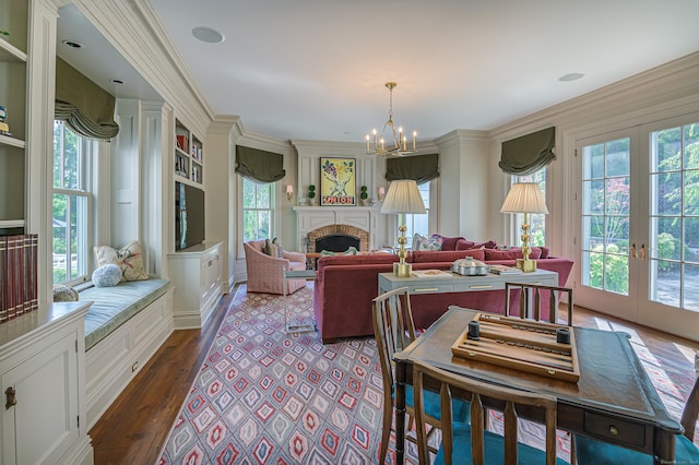 dining space featuring dark hardwood / wood-style flooring, a chandelier, french doors, and ornamental molding