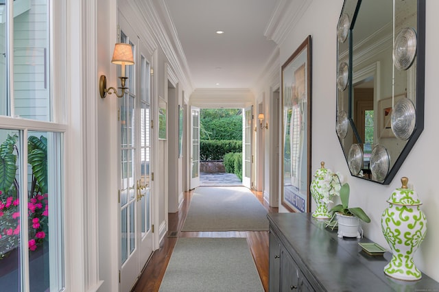 doorway to outside featuring hardwood / wood-style flooring, crown molding, and french doors