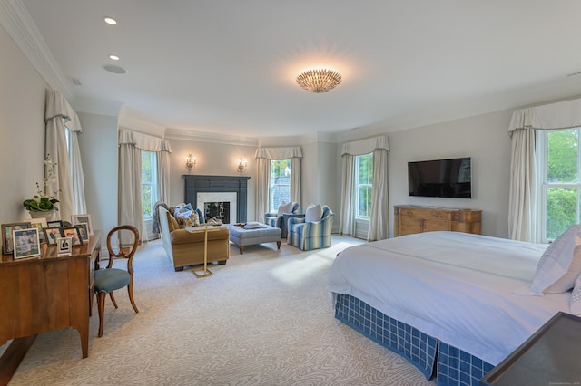 carpeted bedroom with crown molding and a fireplace