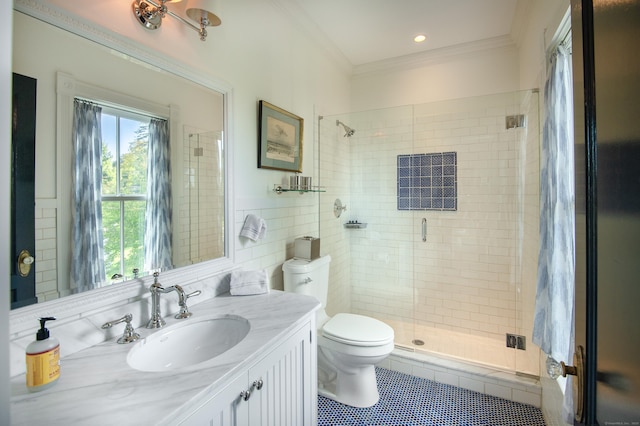 bathroom with toilet, vanity, tile patterned flooring, ornamental molding, and a shower with door