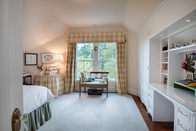 bedroom featuring a textured ceiling and lofted ceiling