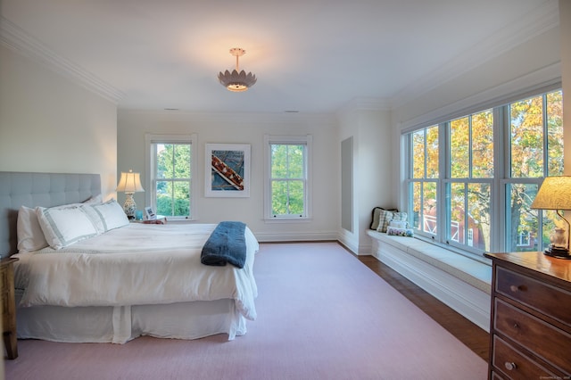 bedroom featuring multiple windows and crown molding