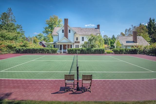 view of tennis court featuring basketball hoop