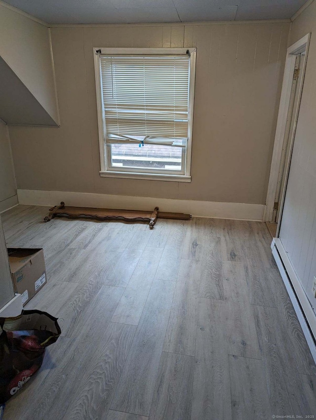 interior space with light hardwood / wood-style floors and baseboard heating