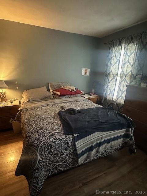 bedroom with hardwood / wood-style flooring