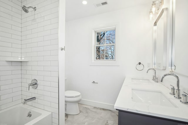 full bathroom featuring vanity, toilet, and tiled shower / bath