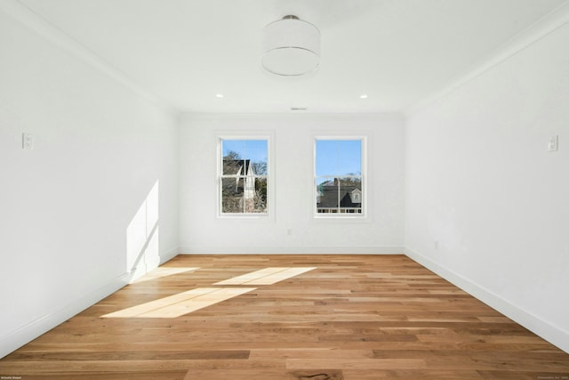 spare room featuring ornamental molding and hardwood / wood-style floors