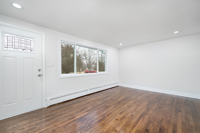 foyer with baseboard heating and dark hardwood / wood-style flooring