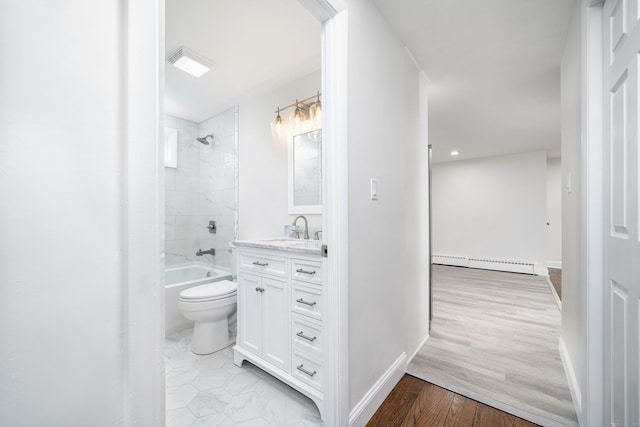 full bathroom with toilet, tiled shower / bath combo, hardwood / wood-style floors, a baseboard heating unit, and vanity