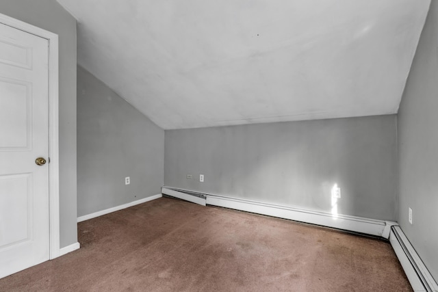 bonus room with a baseboard heating unit, vaulted ceiling, and dark carpet