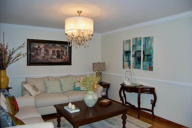 living room featuring wood-type flooring, ornamental molding, and a chandelier