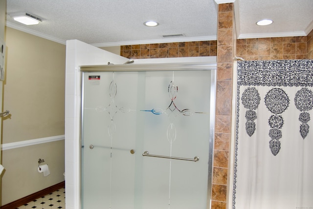 bathroom with a textured ceiling, ornamental molding, and a shower