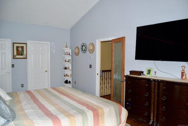 bedroom with dark hardwood / wood-style flooring and vaulted ceiling