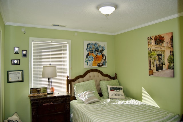 bedroom featuring a textured ceiling and crown molding