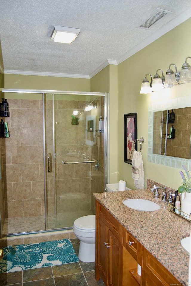 bathroom with a textured ceiling, an enclosed shower, vanity, and toilet