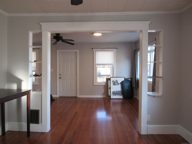 foyer featuring dark wood-type flooring, ceiling fan, and ornamental molding