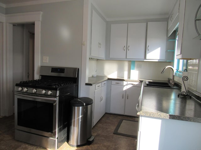 kitchen with sink, stainless steel gas stove, white cabinetry, and ornamental molding