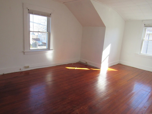 bonus room featuring vaulted ceiling, dark hardwood / wood-style flooring, and a wealth of natural light