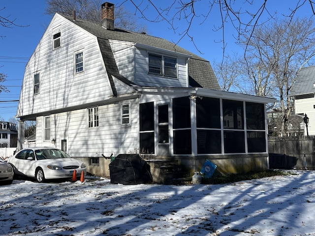 view of front of house with a sunroom