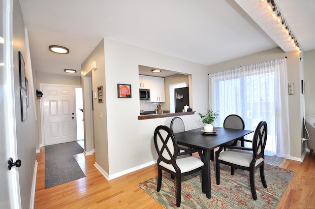 dining area with light wood-type flooring