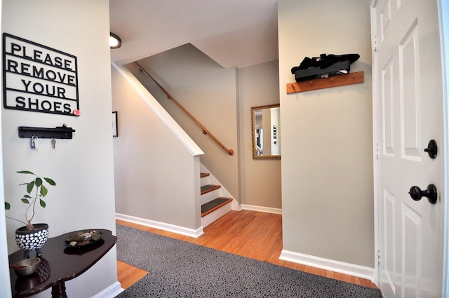 stairs with hardwood / wood-style floors