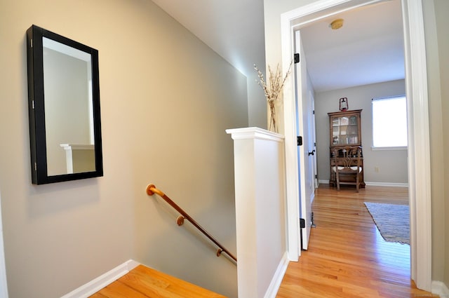 hallway with light hardwood / wood-style flooring