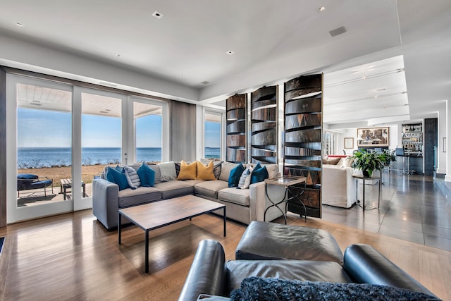 living room featuring hardwood / wood-style floors and a water view