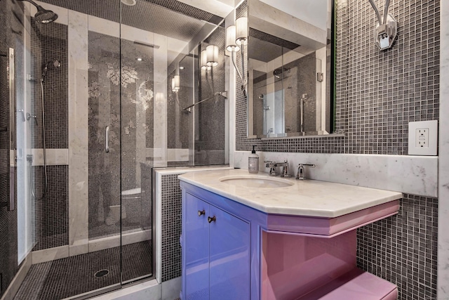 bathroom featuring tile walls, walk in shower, and vanity