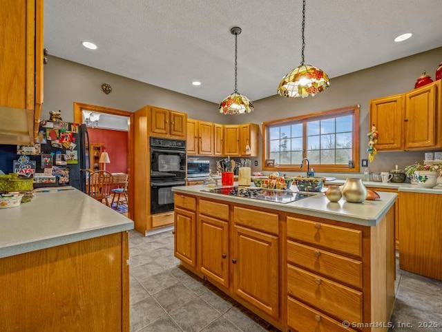 85 Salem Rd, East Haddam, CT 06415 - kitchen with black appliances, light countertops, a kitchen island, brown cabinetry, and recessed lighting