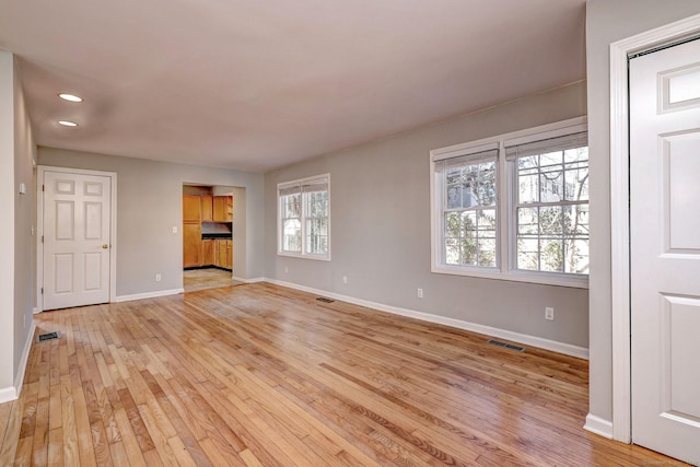 unfurnished living room with light hardwood / wood-style floors