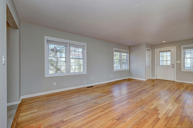 entrance foyer featuring light wood-type flooring and a healthy amount of sunlight