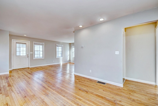 empty room with light hardwood / wood-style flooring