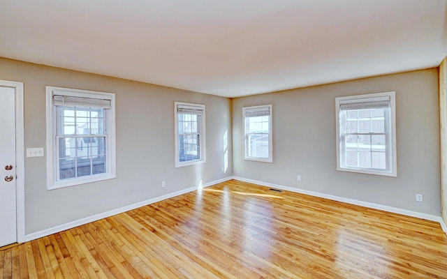 unfurnished room with light hardwood / wood-style floors