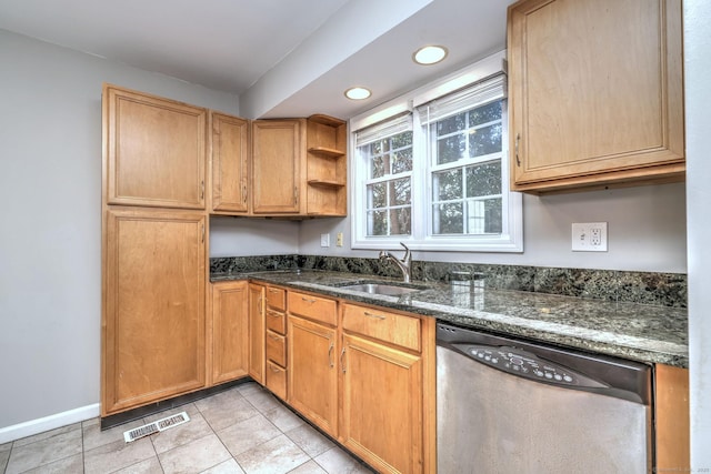 kitchen featuring sink, dishwasher, dark stone countertops, and light tile patterned floors