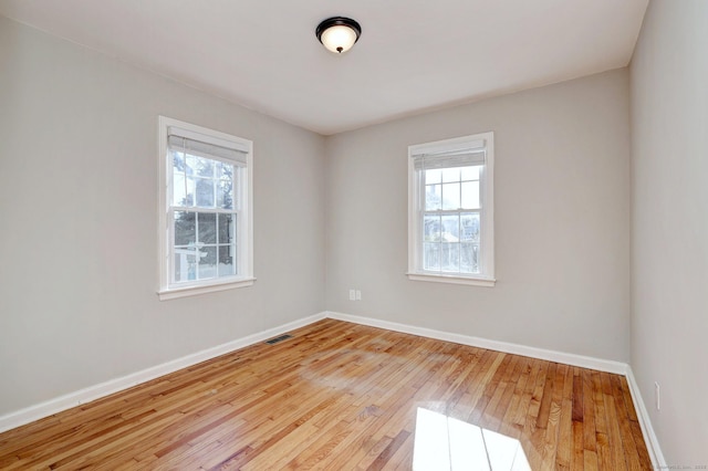 unfurnished room with light hardwood / wood-style flooring and a healthy amount of sunlight