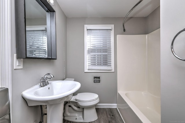 bathroom featuring toilet, shower / bathtub combination, and hardwood / wood-style floors