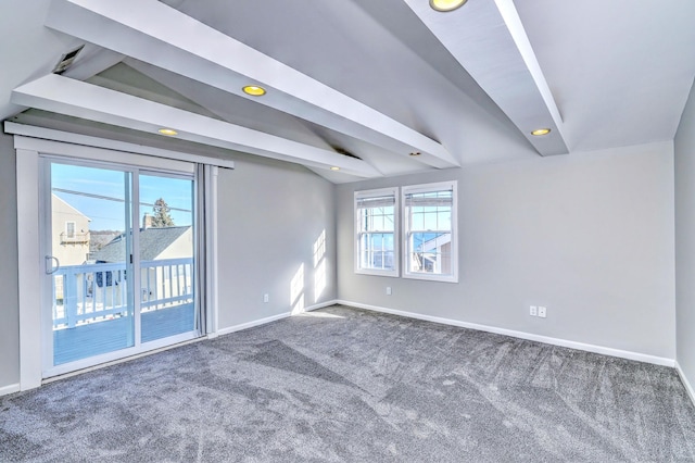 carpeted spare room with vaulted ceiling with beams