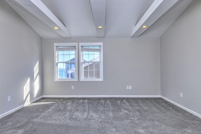 carpeted spare room with vaulted ceiling