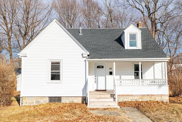 cape cod-style house featuring covered porch