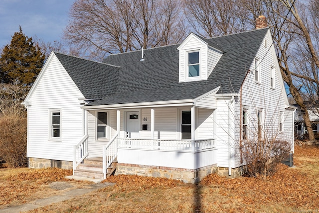 new england style home with covered porch