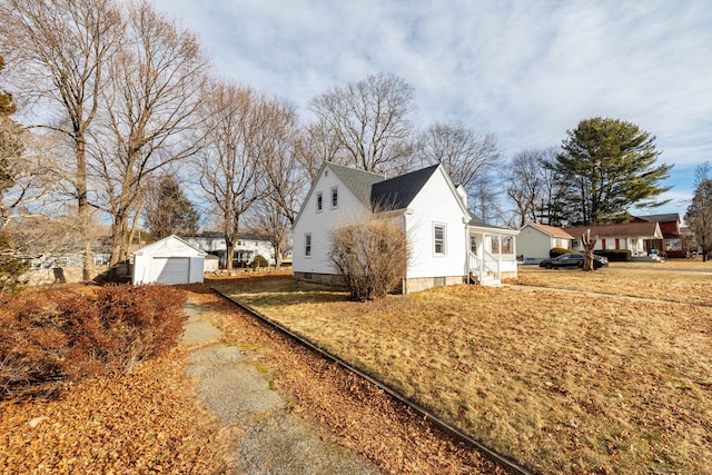 view of side of home with a garage and an outdoor structure