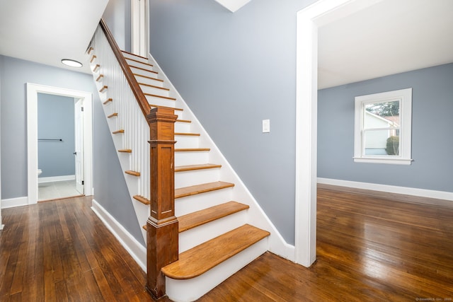 staircase with hardwood / wood-style floors