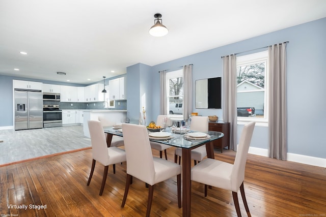 dining room with sink and hardwood / wood-style floors