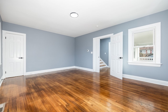 spare room featuring wood-type flooring