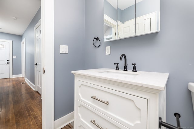 bathroom with hardwood / wood-style floors and vanity