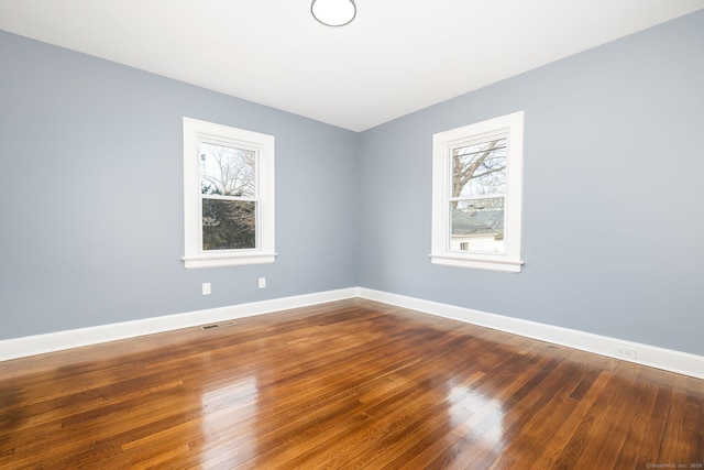 empty room with hardwood / wood-style floors