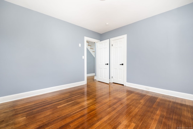 unfurnished bedroom with hardwood / wood-style floors